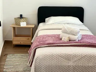 a bed with two pillows on top of it at Casa Sebastião in Faro