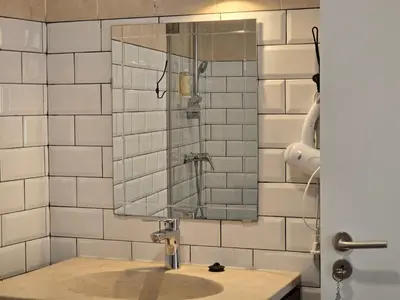 a bathroom with a sink and a mirror at Casa Sebastião in Faro