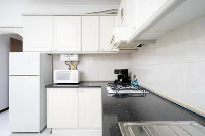 a bedroom with a bed and a large window at Melvin Jones St. 2bedroom apartment in Quarteira