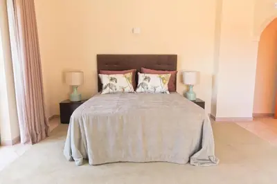a bedroom with a large bed with two lamps at Villa Selena - Beautiful Luxury villa with massage baths in Quinta do Lago