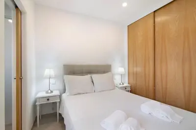 a bedroom with a bed with two white towels on it at Casa da Letinhas in Albufeira