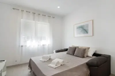 a bedroom with a large bed with two towels on it at Casa da Letinhas in Albufeira