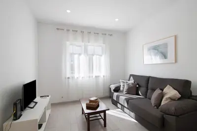 a living room with a couch and a table at Casa da Letinhas in Albufeira
