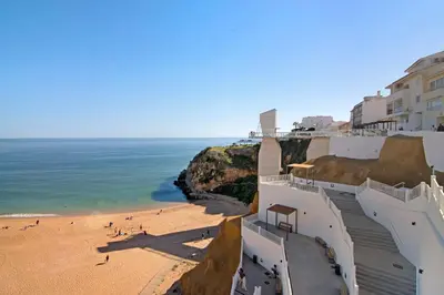 a view of a beach with buildings and the ocean at Casa da Letinhas in Albufeira