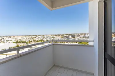 a table with two plates and blue cups on it at The Albufeira Concierge - Pool & Sunset Balconies in Albufeira