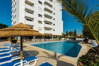 a large swimming pool with blue water at The Albufeira Concierge - Pool & Sunset Balconies in Albufeira