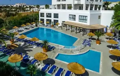 a large swimming pool in the middle of a house at The Albufeira Concierge - Pool & Sunset Balconies in Albufeira