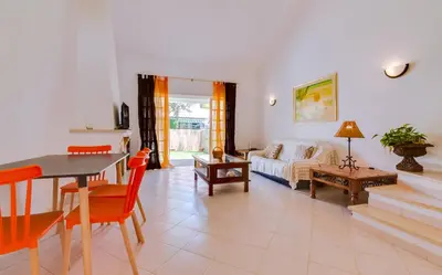a living room with a couch and a table at Small Villa 4Pax -Shared Pool @ Homesbyfc in Albufeira