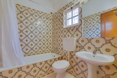 a bathroom with a toilet and a sink at Small Villa 4Pax -Shared Pool @ Homesbyfc in Albufeira
