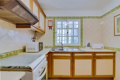 a kitchen with a sink and a window at Small Villa 4Pax -Shared Pool @ Homesbyfc in Albufeira