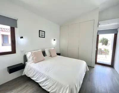 a white bedroom with a large bed with two pillows at Vila Ruby - Private Pool by HD PROPERTIES in Vilamoura