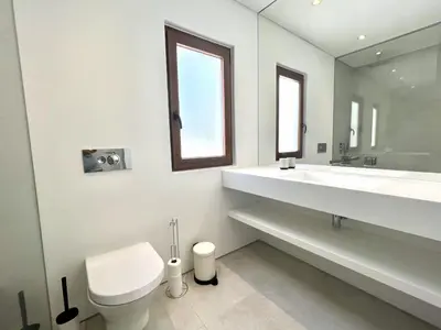 a bathroom with a toilet and a sink and a mirror at Vila Ruby - Private Pool by HD PROPERTIES in Vilamoura