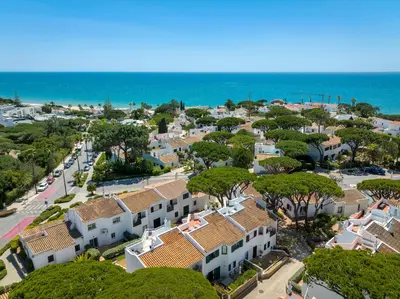an aerial view of a town with houses and the ocean at Villa Isabel in Vale do Lobo