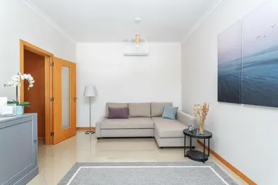 a group of lounge chairs next to a swimming pool at BnB Homes Ocean View Apartment with relax Terrace, 2 Swimming pools & Tennis court in Albufeira