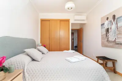 a small television sitting next to a telephone at BnB Homes Ocean View Apartment with relax Terrace, 2 Swimming pools & Tennis court in Albufeira