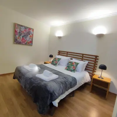 a bedroom with a large bed with two pillows at Casa Alfarroba in Albufeira