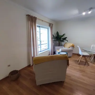 a living room with a couch and a table at Casa Alfarroba in Albufeira