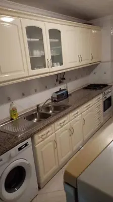 a kitchen with a sink and a washing machine at Casa Alfarroba in Albufeira