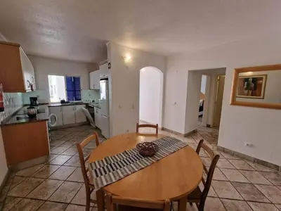 a kitchen and dining room with a table and chairs at douceur d'algarve in Albufeira