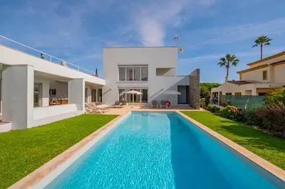 a villa with a swimming pool in front of a house at Villa L in Galé