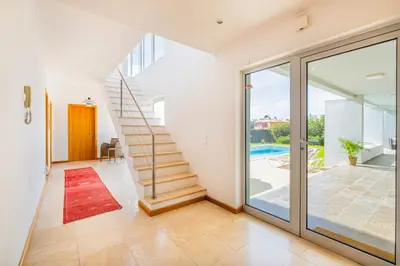 a staircase in a house with a sliding glass door at Villa L in Galé
