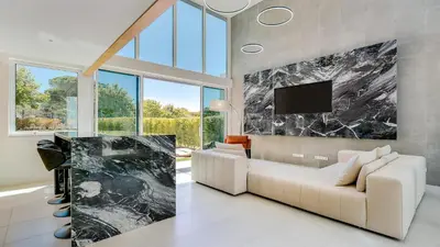 a living room with a white couch and a tv at Villa Serenity- CleverDetails, Central Vilamoura, Sleeps 4 adults and 2 children, located in the center in Vilamoura