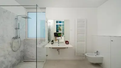 a white bathroom with a sink and a shower at Villa Serenity- CleverDetails, Central Vilamoura, Sleeps 4 adults and 2 children, located in the center in Vilamoura