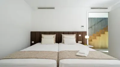 a bedroom with a large white bed with two pillows at Villa Serenity- CleverDetails, Central Vilamoura, Sleeps 4 adults and 2 children, located in the center in Vilamoura