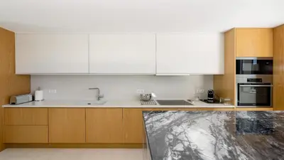a kitchen with white cabinets and a counter top at Villa Serenity- CleverDetails, Central Vilamoura, Sleeps 4 adults and 2 children, located in the center in Vilamoura
