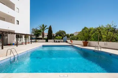 a swimming pool in front of a building at Casa Dos Reis - Albufeira, Center in Albufeira