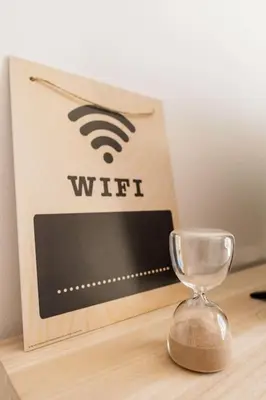 a wooden table with an alarm clock and an hourglass at Casa Dos Reis - Albufeira, Center in Albufeira