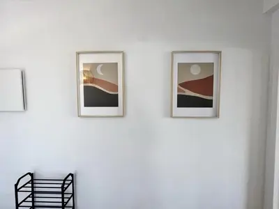 three framed photographs on a white wall at Albufeira Design by Homing in Albufeira