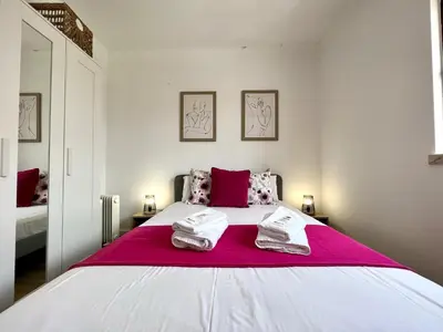 a bedroom with a large bed with two towels on it at Albufeira Design by Homing in Albufeira