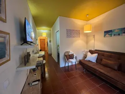 a living room with a couch and a table at Casa Girassol Old Town in Albufeira