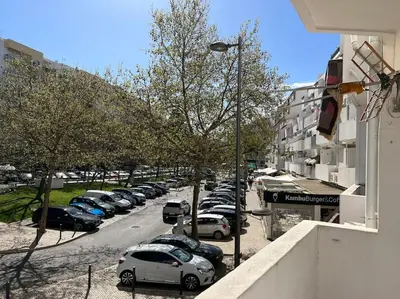 a row of cars parked in a parking lot at Casa Girassol Old Town in Albufeira