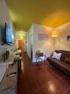 a living room with a couch and a tv at Casa Girassol Old Town in Albufeira