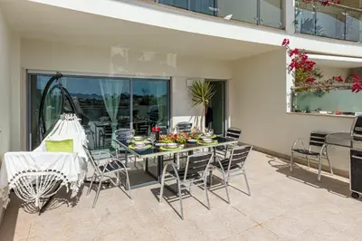 a dining room with a table and chairs on a patio at Villa Seashell in Albufeira