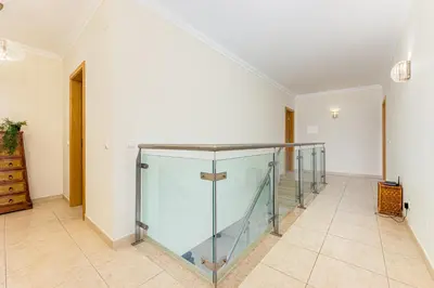 a room with a glass case on a tile floor at Villa Seashell in Albufeira