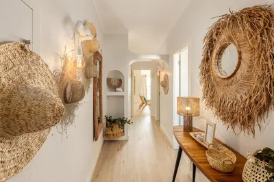 a light fixture hanging over a table with a plant at Apartamento do Atlantico in Albufeira