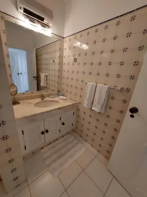 a bathroom with a sink and a mirror at Ancão Beach Apartment in Almancil