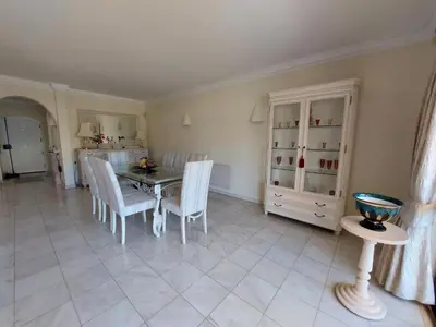 a kitchen and dining room with a table and chairs at Ancão Beach Apartment in Almancil