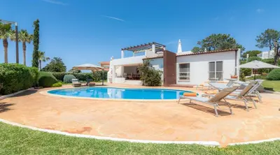 a swimming pool in front of a villa at Villa Prado - Beautiful beachfront villa in Albufeira