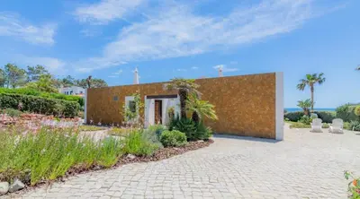 a house with a brick wall at Villa Prado - Beautiful beachfront villa in Albufeira