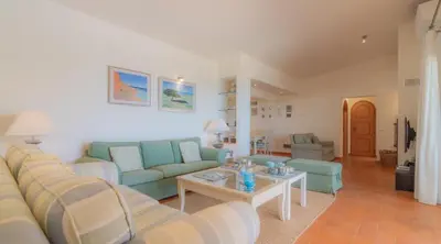 a living room with a couch and a table at Villa Prado - Beautiful beachfront villa in Albufeira