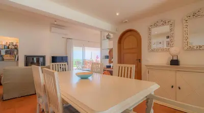 a kitchen and dining room with a table and chairs at Villa Prado - Beautiful beachfront villa in Albufeira
