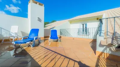a patio with two blue chairs on a balcony at Villa Tulipa - luxury golfing resorts in Almancil