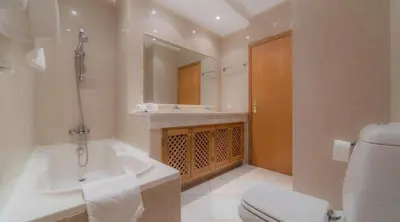 a bathroom with a tub and a toilet and a sink at Villa Tulipa - luxury golfing resorts in Almancil