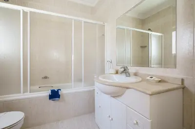 a white bathroom with a sink and a toilet at Villa White Cottage by SAPvillas in Vilamoura