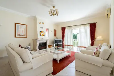 a living room with white furniture and a fireplace at Villa White Cottage by SAPvillas in Vilamoura