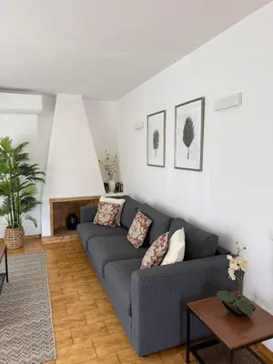 a living room with a couch and a table at COZY APARTMENT OURA BEACH in Albufeira